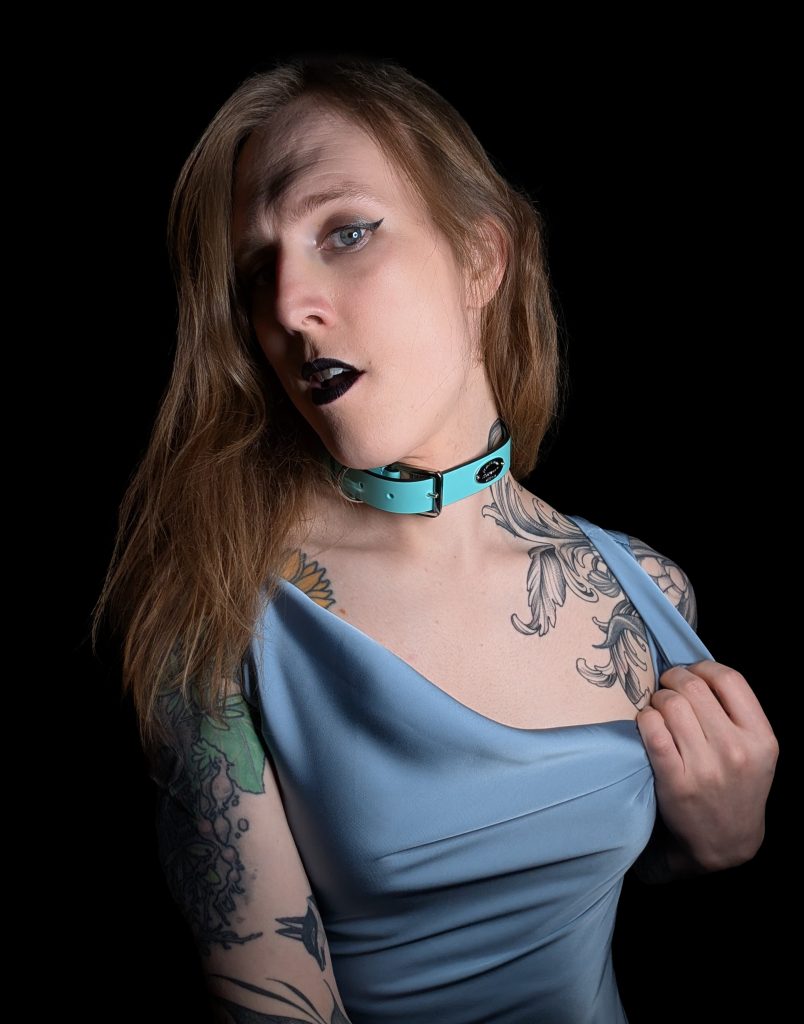 The Hague trans dominatrix Calliope the Coyote, pulling her dress to the side.